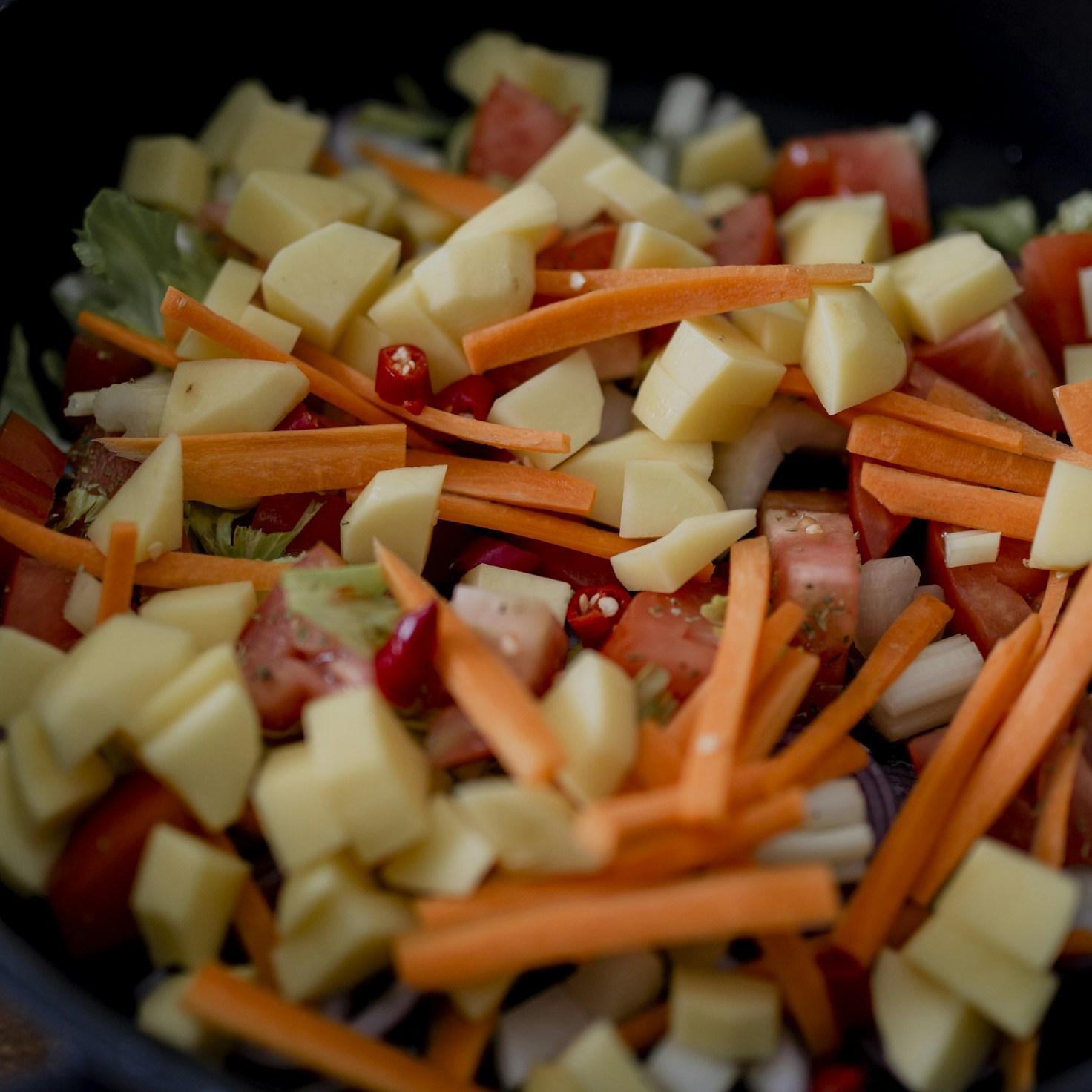Community members collaborating in a modern kitchen space, sharing recipes and cooking techniques